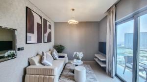 a living room with a couch and a large window at STAY BY LATINEM Luxury 1BR Holiday Home CVR A1410 near Burj Khalifa in Dubai