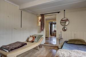a bedroom with two beds and a mirror at Chalet Nostalgie in Chateau-d'Oex