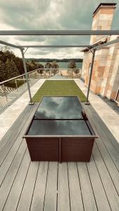 a table on the deck of a house at Hotel Bellevue in Charzykowy