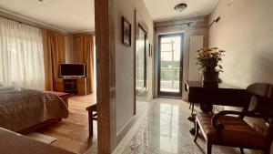 a bedroom with a bed and a desk and a television at Hotel Bellevue in Charzykowy +7 photos