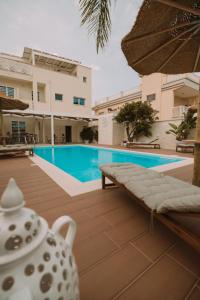 a villa with a swimming pool and a house at Dimora Nesea in Cozze