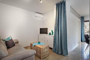 a living room with a couch and a tv at Marina Real 2434 in Manilva