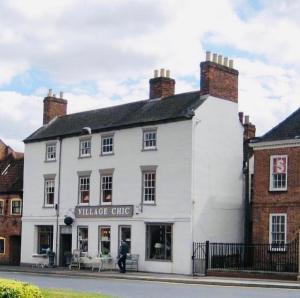 a white building with a man standing in front of it at Château 9 Neuf in Newark upon Trent