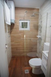 a small bathroom with a toilet and a shower at House for rest in Mostar