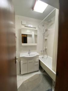 a bathroom with a sink and a shower and a tub at Квартира на Атакенте у Выставки in Almaty