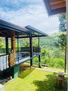 a house with a balcony with a view at Springvalley Holiday Home in Badulla