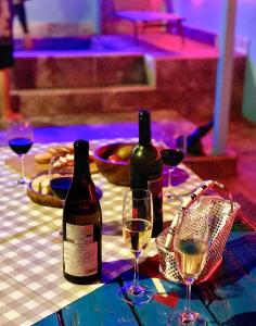 two bottles of wine sitting on a table with glasses at Hoengseong Haru Self check-in Hotel in Hoengsong