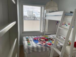 ヘルシンキにあるCasa Onniの小さな客室で、二段ベッド1組、はしごが備わります。