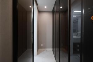 a glass door in a room with a bathroom at Zizel Raonjae full house in Seoul