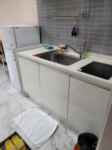 a kitchen with a sink and a refrigerator at Leve de Mongdol Pension in Geoje  +182 photos
