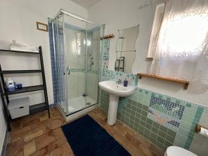 a bathroom with a sink and a glass shower at Villino Tokupellon Apartments in Cupello +118 photos
