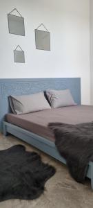 a bedroom with a bed with a blanket and a fur at Maison dolce vita in Ţūzah