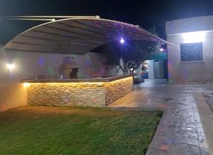 a person standing under an umbrella at night at Maison dolce vita in Ţūzah +4 photos