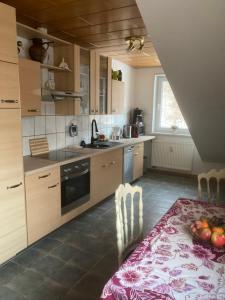 a kitchen with a table with a bowl of fruit on it at Immensee in Ronshausen