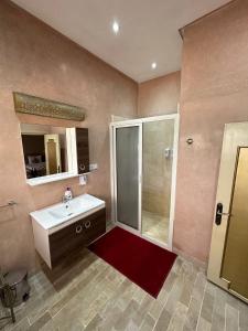 a bathroom with a shower and a sink and a mirror at Riad Annada in Marrakesh +111 photos