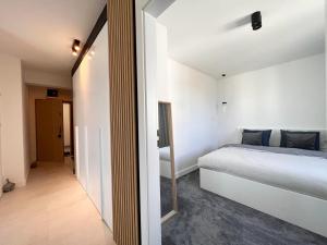 Posteľ alebo postele v izbe v ubytovaní Apartament Orro Mare