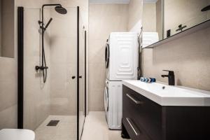 a bathroom with a refrigerator and a sink and a shower at Corner Apartments in Bergen +37 photos