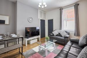 a living room with a couch and a table at Host & Stay - Belford Apartment in North Shields