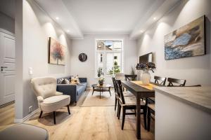 a living room and dining room with a table and chairs at Corner Apartments in Bergen