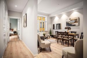 a living room and dining room with a dining table at Corner Apartments in Bergen