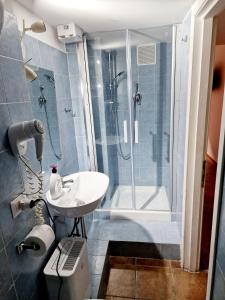 a bathroom with a shower and a sink and a toilet at Lofts In Rome in Rome