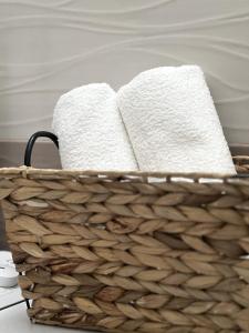 a basket filled with towels on a table at Studio Apartman Lucija in Osijek