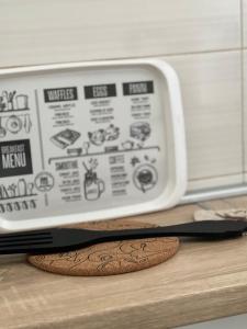 a microwave with a cookie and a knife on a counter at Studio Apartman Lucija in Osijek