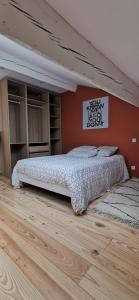 a bedroom with a bed and a wall at Duplex Dax in Dax