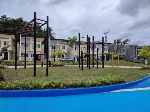 a playground in a park with swings at 2 Storey House 4 BR Diamond Heights Near Airport in Davao City +9 photos
