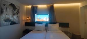 Katil atau katil-katil dalam bilik di Hotel 4 Estações