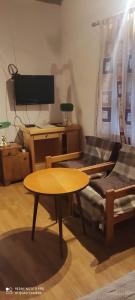 a living room with a table and a couch at Apartman Šipak in Fužine