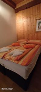 a bedroom with a bed with pillows on it at Apartman Šipak in Fužine