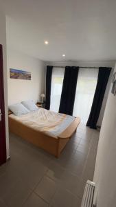 a bedroom with a large bed with black curtains at les gites de la Bellezza in Bois-de-Cené