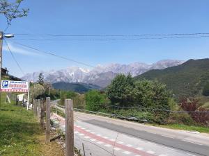 an empty road with mountains in the background at Hostal La Parrilla in Mieses