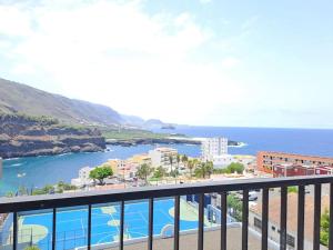 a view of the ocean from a balcony at Apartamento en Playa San Marcos in Icod de los Vinos +8 photos