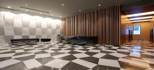 a lobby with a piano and a checkered floor at Secure Central Eclectic 1BRs in Luxury Residence w 2 Pools Gym Sauna Basketball Court Meeting Room Free Parking Concierge close to Istanbul Expo Center in Istanbul