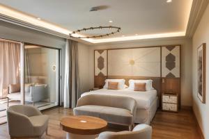 a bedroom with a bed and a chair and a table at Castelfalfi in Castelfalfi