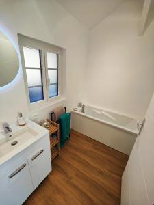 a bathroom with a sink and a bath tub at La maison du bien-être in Le Bois-Robert +25 photos