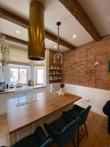 a kitchen with a wooden counter and a brick wall at Apartments PSD - Anny Łajming 2C in Słupsk