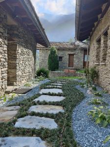 a garden with a stone walkway in front of a building at Ai Tetti Nuovi in Roccaforte Mondovì