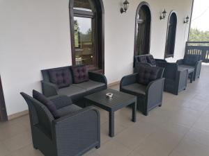 a waiting area with chairs and tables and a table at Rusaliite Adventure House in Bachevo