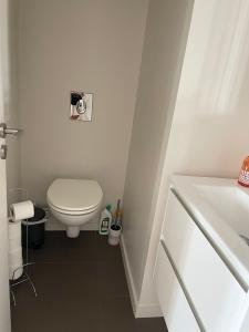 a white bathroom with a toilet and a sink at Cannes Vieux Port Seafront & Seaview, fast wifi in Cannes