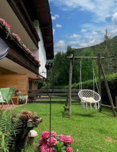 un columpio en el patio de una casa en Lilly Chalet- Apartments with private sauna, close to ski lifts en Bad Kleinkirchheim