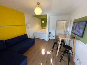 a living room with a couch and a table at Buntes Wohnen in Düren in Düren - Eifel