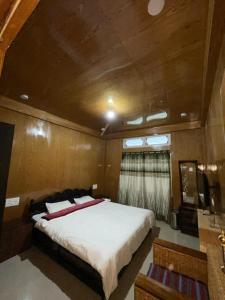 a bedroom with a large bed in a boat at Vamoose Sonam Guest House Tawang in Tawang