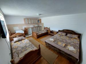 a room with two beds and a living room at DOBRA VODA in Vojno Selo