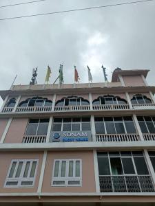a building with people standing on top of it at Vamoose Sonam Guest House Tawang in Tawang