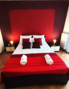 a bedroom with a large bed with a red headboard at Villetta di Anastasia 1 tropea in Filandari +22 photos