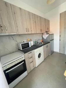 a kitchen with a microwave and a dishwasher at Διαμέρισμα στη Ναύπακτο in Nafpaktos +5 photos
