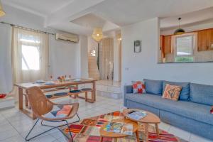 a living room with a blue couch and a table at Villa Pilu in Kaş